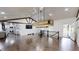 Expansive living area with hardwood floors, modern lighting, and a view into the kitchen at 9680 Ephesus Church Rd, Villa Rica, GA 30180