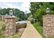Community entrance showcasing stone pillars and manicured landscaping at 1307 Madison Se Ln, Smyrna, GA 30080