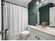 Stylish bathroom featuring a white vanity, gold fixtures, and a modern shower curtain at 2377 Emory Ln, Marietta, GA 30068