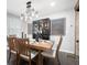 Dining room features a wooden table set under a modern chandelier, with stylish decor and artwork at 2377 Emory Ln, Marietta, GA 30068