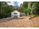 View of home nestled in wooded area with lush foliage, and long driveway at 2377 Emory Ln, Marietta, GA 30068