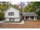 Charming two-story home featuring a white brick and vinyl exterior with a cozy front porch and a well-maintained lawn at 2377 Emory Ln, Marietta, GA 30068