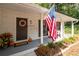 Charming front porch featuring a decorative wreath, an American flag, seating, and seasonal decorations at 2377 Emory Ln, Marietta, GA 30068