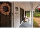 A welcoming front porch with seating, house number, brick facade, and seasonal decorations at 2377 Emory Ln, Marietta, GA 30068