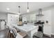 Bright kitchen with white cabinets, marble countertops, stainless steel appliances, and a large island at 2377 Emory Ln, Marietta, GA 30068