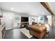 Spacious living area with hardwood floors, comfortable seating, and a view of the stairs and back patio at 2377 Emory Ln, Marietta, GA 30068