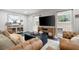 Comfortable living room featuring a brown leather sofa set and a large TV for entertainment at 2377 Emory Ln, Marietta, GA 30068