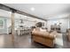 Open-concept living area with a cozy leather sofa, hardwood floors, and a seamless flow to the dining and kitchen areas at 2377 Emory Ln, Marietta, GA 30068