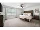 Spacious main bedroom featuring neutral tones, carpet, ceiling fan and plenty of natural light at 2377 Emory Ln, Marietta, GA 30068