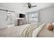 Bright, open main bedroom featuring ensuite bath access, ceiling fan, and carpet at 2377 Emory Ln, Marietta, GA 30068