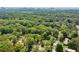 Aerial shot showing the property lines, wooded property, and surrounding city views at 3383 Campbell Se Rd, Smyrna, GA 30080