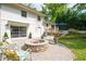 Backyard featuring brick patio, fire pit, ample seating, and lush landscaping at 3383 Campbell Se Rd, Smyrna, GA 30080