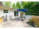 Backyard featuring an outdoor dining space under an umbrella and a brick patio with garden at 3383 Campbell Se Rd, Smyrna, GA 30080