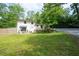 Spacious backyard featuring mature landscaping, an outdoor dining area, and lush lawn at 3383 Campbell Se Rd, Smyrna, GA 30080