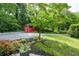 Spacious backyard featuring mature landscaping and a charming red storage shed at 3383 Campbell Se Rd, Smyrna, GA 30080