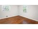 Inviting bedroom with gleaming hardwood floors and natural light from the windows, creating a warm ambiance at 3383 Campbell Se Rd, Smyrna, GA 30080