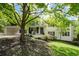 Charming two-story home with white brick, dark shutters, and a covered carport nestled in a tree-filled yard at 3383 Campbell Se Rd, Smyrna, GA 30080