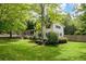 Well-manicured lawn and landscaped yard showcase this two-story home with white brick and dark shutters at 3383 Campbell Se Rd, Smyrna, GA 30080