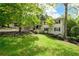 Beautifully landscaped yard featuring a two-story home with white brick and dark shutters at 3383 Campbell Se Rd, Smyrna, GA 30080