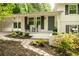 Inviting front porch with rocking chairs and manicured landscaping with dark shutters and a painted door at 3383 Campbell Se Rd, Smyrna, GA 30080