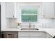 Bright kitchen features white cabinets, sleek stainless appliances and a view of the backyard at 3383 Campbell Se Rd, Smyrna, GA 30080