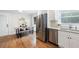 Open-concept kitchen features stainless steel appliances, white cabinets, and a breakfast nook with a sliding door at 3383 Campbell Se Rd, Smyrna, GA 30080