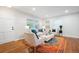 Bright living room with hardwood floors, modern furniture, and a door leading to the exterior at 3383 Campbell Se Rd, Smyrna, GA 30080