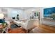 Bright living room with hardwood floors, modern furniture, and an open view to the dining and kitchen area at 3383 Campbell Se Rd, Smyrna, GA 30080
