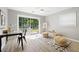 Living area with modern flooring, a sliding glass door, and a view of the outdoor patio, blending indoor and outdoor living at 3383 Campbell Se Rd, Smyrna, GA 30080