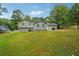This backyard has a lush green lawn and mature trees at 798 Bankshire Dr, Suwanee, GA 30024