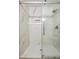 Sleek bathroom shower featuring clear glass and showerhead, with marble-look tile walls and floors at 798 Bankshire Dr, Suwanee, GA 30024