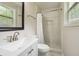 Bathroom featuring a shower with a white curtain, window for natural light, and marble-look tile at 798 Bankshire Dr, Suwanee, GA 30024