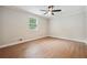 Bright bedroom with a large window, ceiling fan, and wood flooring, providing a cozy retreat at 798 Bankshire Dr, Suwanee, GA 30024