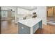 Kitchen featuring a center island with quartz countertop, stainless steel appliances, and sleek white cabinets at 798 Bankshire Dr, Suwanee, GA 30024