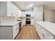 Spacious kitchen with white cabinets, stainless steel appliances, and a center island for meal preparation at 798 Bankshire Dr, Suwanee, GA 30024