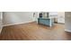 Bright living room features wood-look flooring and an open concept kitchen area with a blue island at 798 Bankshire Dr, Suwanee, GA 30024