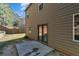 Exterior home view featuring a flat backyard with a concrete patio and sliding glass doors at 820 Lake Chase, Fairburn, GA 30213