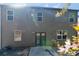 Exterior of a two-story home featuring double doors leading to a patio and a well-maintained yard at 820 Lake Chase, Fairburn, GA 30213