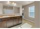 Bright bathroom featuring a double sink vanity, a large mirror, and natural light from the window at 820 Lake Chase, Fairburn, GA 30213