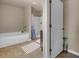 Well-lit bathroom featuring a bathtub, shower with curtain, and neutral color scheme at 820 Lake Chase, Fairburn, GA 30213
