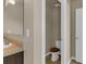 Powder room with a toilet, vanity mirror, and tile flooring providing a convenient and stylish space at 820 Lake Chase, Fairburn, GA 30213