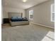 Bedroom featuring a large bed with a padded headboard, natural light, and neutral carpet at 820 Lake Chase, Fairburn, GA 30213