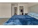 Bedroom view showcasing a blue bedspread and access to a hallway and closet at 820 Lake Chase, Fairburn, GA 30213