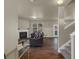 Living room with cozy fireplace, wood floors, and a staircase at 820 Lake Chase, Fairburn, GA 30213