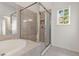 Spacious bathroom featuring a glass-enclosed shower and soaking tub at 2301 Waters Edge Trl, Roswell, GA 30075