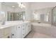 Bright bathroom with double vanity, a large mirror and separate tub and shower at 2301 Waters Edge Trl, Roswell, GA 30075