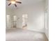 Light-filled bedroom showcasing neutral walls and carpet with an open doorway to the bathroom at 2301 Waters Edge Trl, Roswell, GA 30075