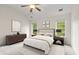 Bright bedroom with large windows, neutral decor, modern furnishings, and a ceiling fan at 2301 Waters Edge Trl, Roswell, GA 30075