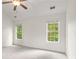 Bright bedroom featuring a ceiling fan, two windows and neutral walls at 2301 Waters Edge Trl, Roswell, GA 30075