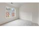 Cozy bedroom with a view of the neighborhood through a large window at 2301 Waters Edge Trl, Roswell, GA 30075